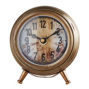 Inspired by flea market finds, the Antiqued Brass Style Table Clock has an aged brass patina and an elegant design, reminiscent of 18th century style. This charming clock is perfect for a desk or side table. Features an aged, rustic face. Requires 1 AA battery (not included). 3.5" Dia x 4"H 