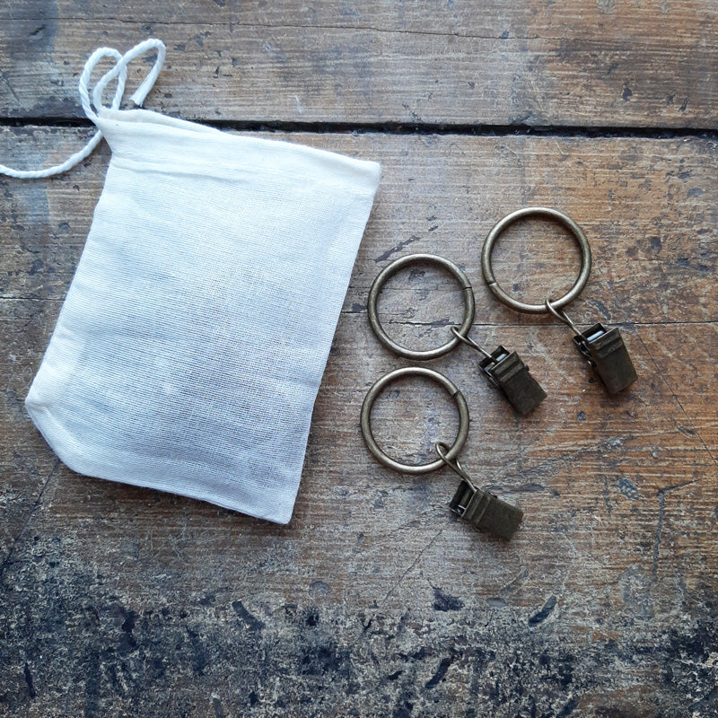 These Curtain Ring Clips are perfect for creating an instant vintage look with any fabric. Made of heavy-duty metal with an antiqued brass finish, the clips are anti-rust and don’t fade. They fit easily over curtain rods up to 5/8 inch and provide smooth sliding when it comes time to open or close your drapes. Each clip holds up to 3 pounds. The rings are 1 inch in diameter and compatible with up to 5/8 inch drapery rod and tension rods. Set of 10