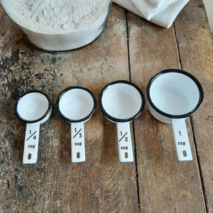 Not only useful, but our White Enamelware Measuring Cups, Set of Four, has a ton of charm to add to your farmhouse kitchen. The vintage style white enamelware cups, with black rims, nests together neatly, and they will surely inspire you to cook up something new. Makes a great gift for those who love to cook and bake. Set of four: 1 cup, 1/2 cup, 1/3 cup, 1/4 cup 