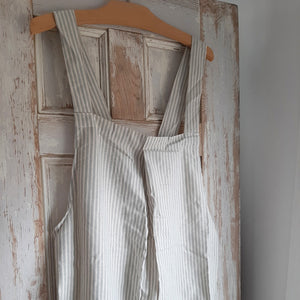 Whether you are crafting or cooking, the Farm Kitchen Smock Apron is perfect for anytime you need coverup. Easily slips over your head so no tying needed. The straps criss cross in back, which is open, so it slips on with ease. Handy pockets on front, made of sustainable 100% cotton with powder blue or mustard stripes. One size fits most.