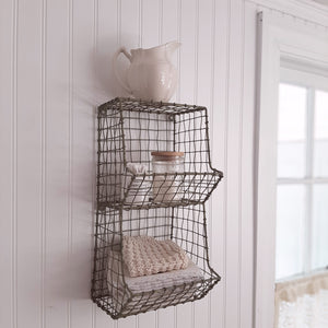 This wire wall bin offers vintage charm to any room in your farmhouse. Our General Store Wire Wall Bin features two equally sized bins. Stash away potting shed materials or keep spices close at hand in the kitchen. Comes with keyholes on back for hanging. Aged finish has a slightly oxidized light green patina. Accessories are not included. 7.5”L x 7”W x 16”H