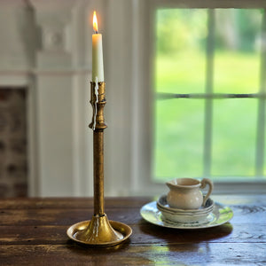 The Golden Aged Taper Candle Holders are crafted with a simple elegance and feature a distressed gold patina giving them a vintage charm. The simple design includes a base that's perfect for catching wax, saving your tabletop from damage. Made of metal with a distressed antique gold look.