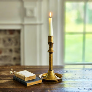 The Golden Aged Taper Candle Holders are crafted with a simple elegance and feature a distressed gold patina giving them a vintage charm. The simple design includes a base that's perfect for catching wax, saving your tabletop from damage. Made of metal with a distressed antique gold look.