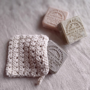 This super soft vintage style Hand-Knit Soap Sock adds a bit luxury to your bathing experience. Handmade of 100% Certified Organic Cotton, this knit soap bag fits a bar soap and creates a rich lather as you wash. Designed for scrubbing without damaging the skin. It promotes circulation and gentle exfoliation. Machine wash/dry. 5"L x 4.5"W x 0.25"H