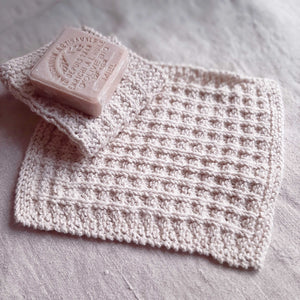 This super soft vintage style Hand-Knit Waffle Washcloth adds a bit luxury to your bathing experience. Handmade of 100% Certified Organic Cotton, this knit washcloth, with its waffle weave pattern, is designed for scrubbing without damaging the skin. It promotes circulation and gentle exfoliation. Machine wash/dry. Set of two. 8.5"L x 8"W