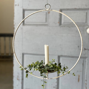 Our Hanging Halo Taper Holder features a creamy white chippy paint finish with shabby chic-inspired style. The halo offers a charming way to display taper candles. Add greenery for a creative twist or leave it plain for a simple elegance. This lightweight halo taper holder has a loop on to for hanging. 14.5"Diam