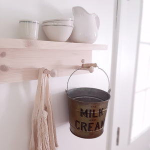 Whether you're gathering flowers from the garden, eggs from the chicken coop, or keeping your home organized, this set of two Milk and Cream Buckets will help get the job done. These galvanized buckets feature a rustic golden finish and vintage style wood handle grips. Perfect for utensils, flowers and so much more!