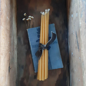 These slim Monastery Beeswax Taper Candles offer a unique touch that will add a sweet charm and the warm scent of honey to any room. These beautiful 1/4" by 8" tapered beeswax candles make a stunning natural element that provide soft bright light as they burn. Come as a set of 10 wrapped in velvet ribbon. Candles burn for 1.5 hours. Perfect to use for meditation or as birthday candles.