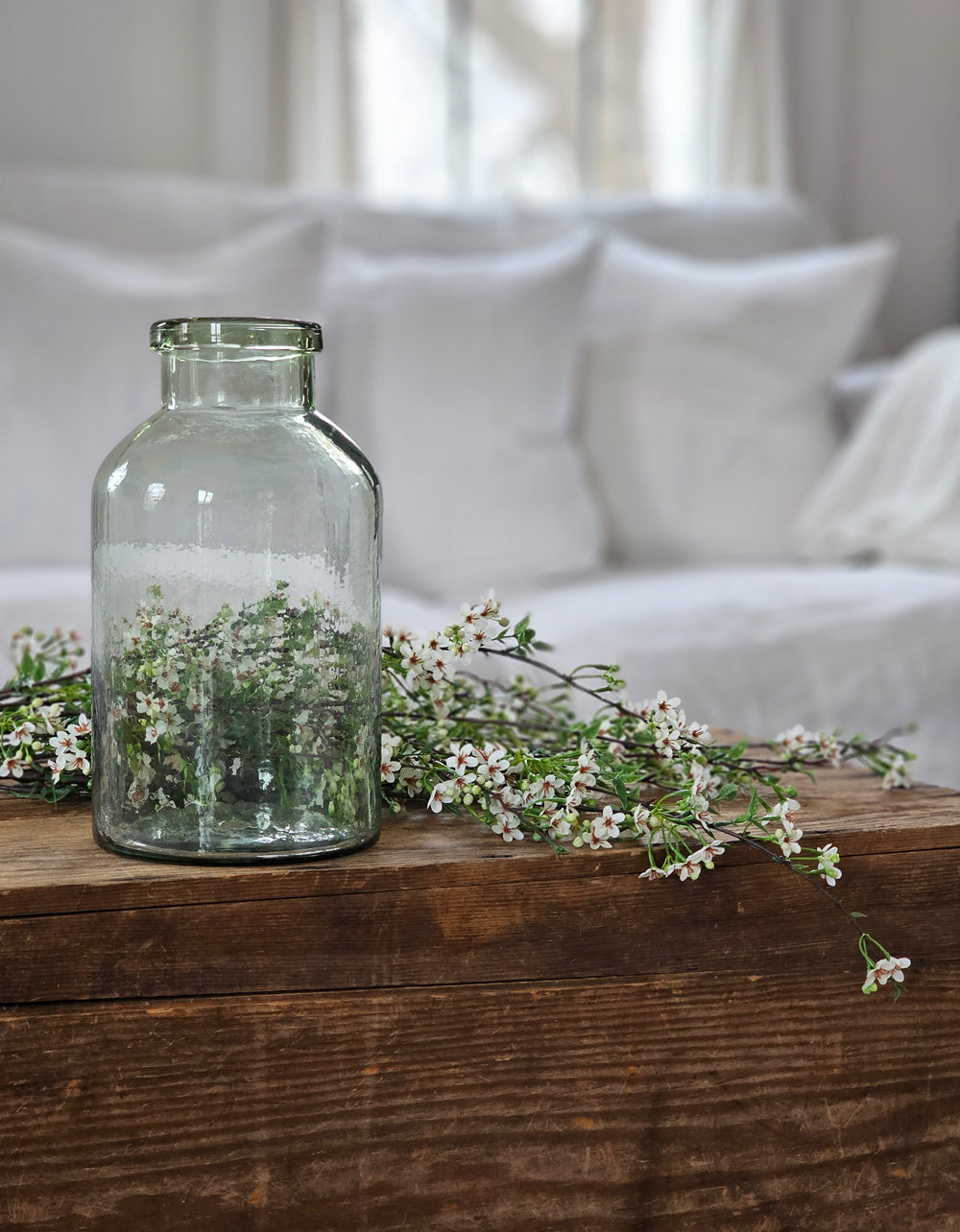 https://farmhousewares.com/cdn/shop/products/Recycled-Glass-Jar-Vase-with-Tiny-White-Blossom-Branches-liv-AMB-V_2048x.jpg?v=1696863455