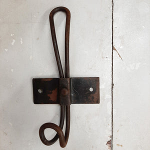 Reminiscent of vintage wire hooks found in old schoolhouse coat rooms or farmhouse bedrooms, this charming Rusty Wire Coat Hook is perfect for farmhouse living. Whether your style is country farmhouse or vintage industrial, these old-fashioned wire hooks have a simple design that will be at home in any mudroom, kitchen or bedroom.  The distressed wire hook has a rusty finish and a flat back panel with two holes for hanging.