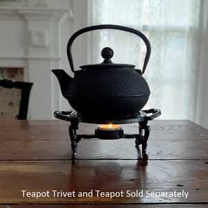 The Teapot Trivet and Warmer is perfect for adding an old-time touch with tons of practicality. This cast iron teapot trivet is designed to keep your tea pot warm. It features a tea light candle holder to warm tea or pots of milk. Only suitable for tea light candles less than 4cm / 1.6" in size (not included). 7"L(with handles) x 5" Diam surface x 2.9"H Trivet only.