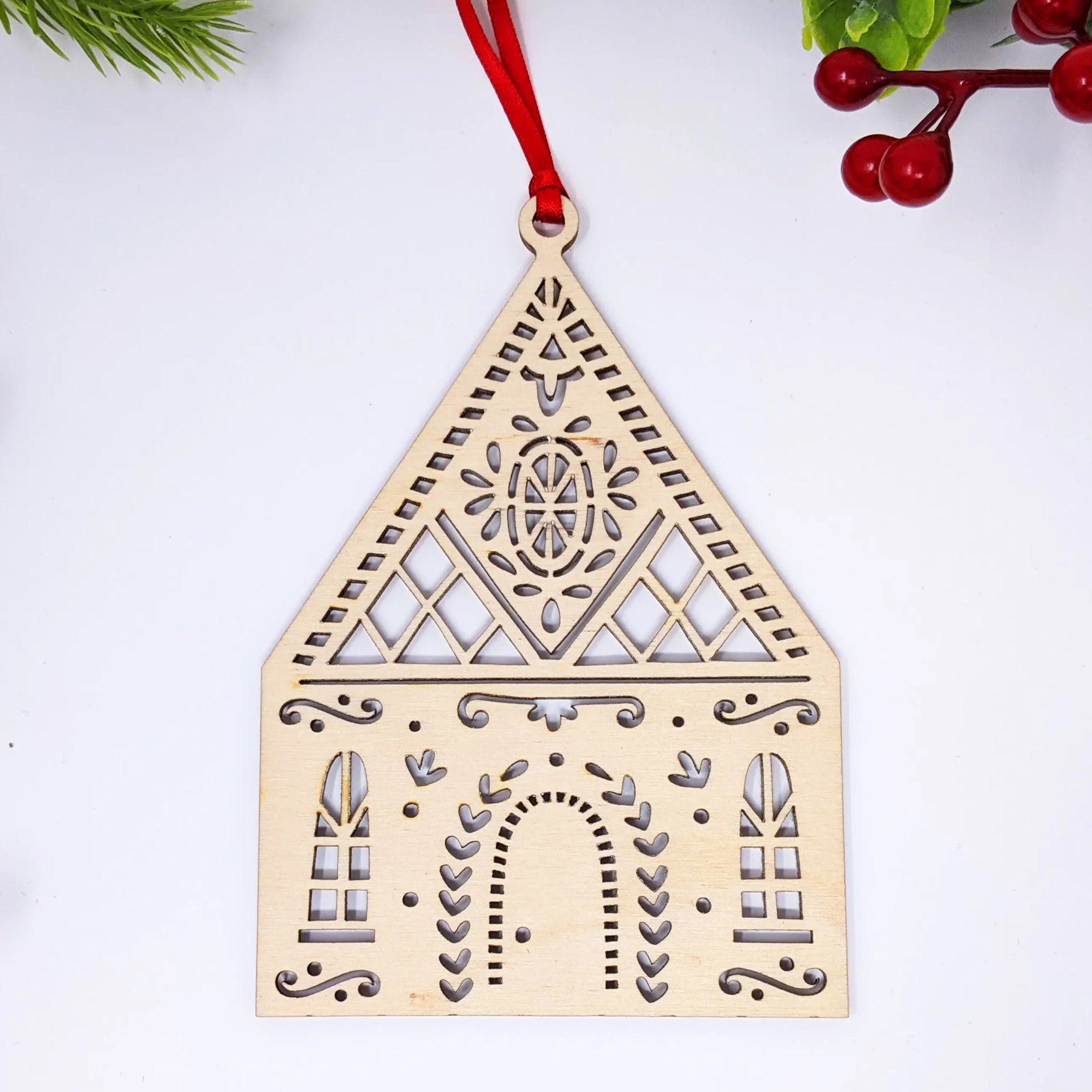 This Tudor Cottage Wood Ornament is handmade in the USA. This little putz house ornament is inspired by Tudor architecture and fairy tale villages nestled throughout Europe. Made in the USA. 5" L x 4" H