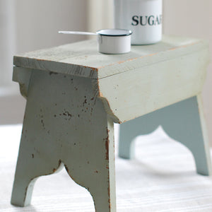 Our Vintage Farmhouse Stool features distressed wood with a chippy paint finish that is quintessential farmhouse style. There are so many uses for the primitive style wood stool. Decorate a vintage bedroom, create cottage style ambiance in any room, or use it as a wood pedestal riser in your farmhouse kitchen. This decorative accent has a shabby chic cottage feel. 10" x 8" x 12"H