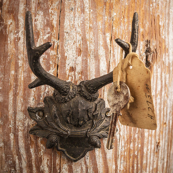 This Antler Hook with Acorn Detail brings vintage cabin style to any room.  Features a dark metal finish with an acorn and leaf design. A fresh twist on rustic lodge decor, this antler hook makes a great wall accent for any room and is perfect for hats, leashes and more. (hardware not included.) 3"L x 2"W x 4.5"H