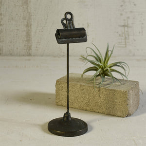 Industrial style clips are given a leg up on display when mounted on cast iron bases. Our Vintage Style Bookkeepers Clip on Stand is perfect for photos, a menu, a memo, or to hold table numbers at a reception. This vintage style clip has a perfectly aged patina and can be used in so many ways.  3.5x3.5x10.5