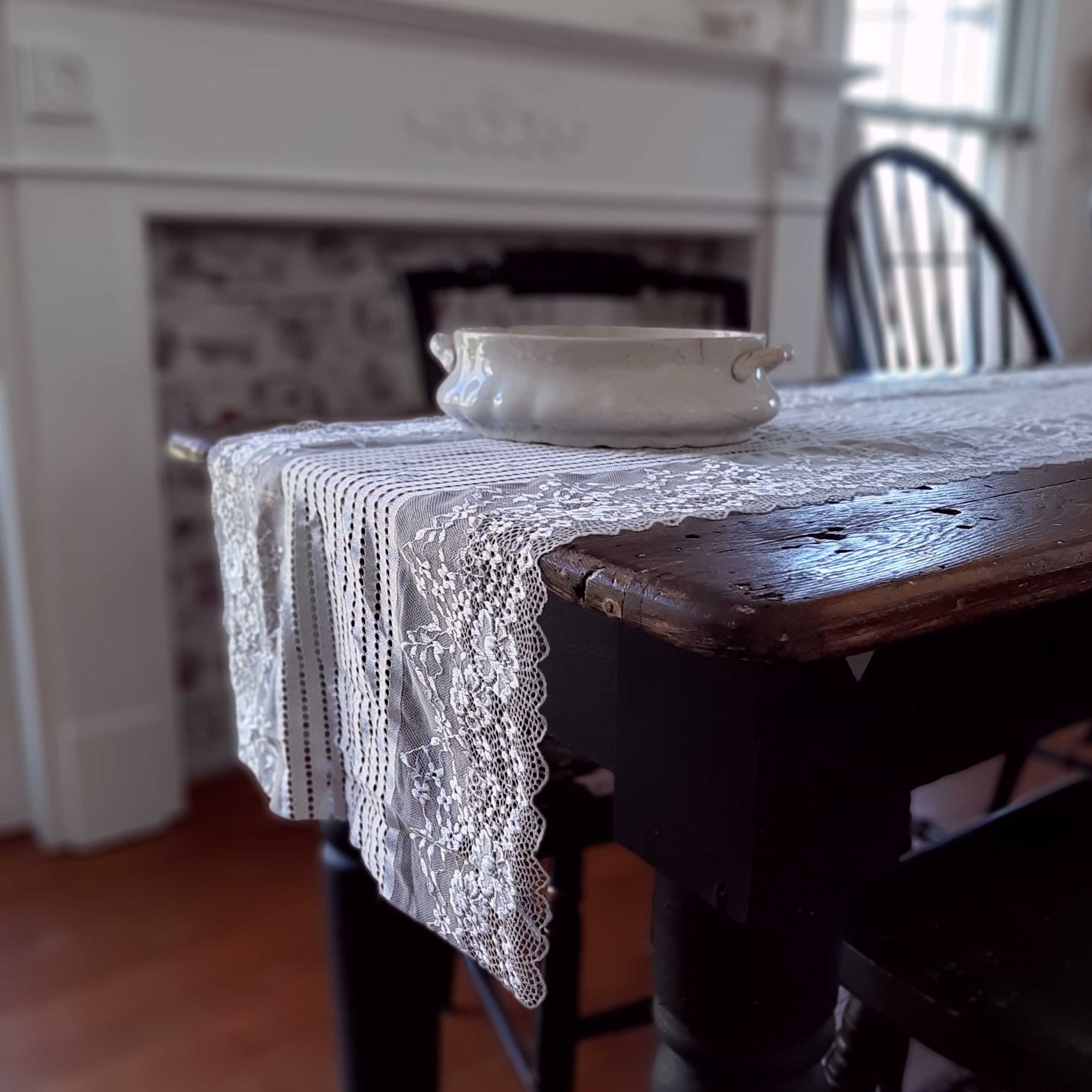 Our Old-World Lace Table Runner adds a light and breezy touch of elegance to your home. This sheer lace runner has a dreamy quality and creates instant vintage charm that is perfect for country cottage living. Translucent white lace is embroidered with a floral design along the edges with stripes down the center. Blend of cotton, linen and polyester. 15.7”W x 78.7”L