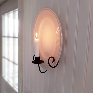 Instead of keeping those beautiful vintage dishes stashed away, put them on display with our Taper Candle Sconce and Plate Holder. This vintage style metal dish display makes it easy to show off your favorite floral plates. Use a vintage style mirror to create a warm glowing reflection with the candle. The primitive design of this wall mounted plate rack with candle holder is inspired by colonial candle plates and fits right in to farmhouse style decor.