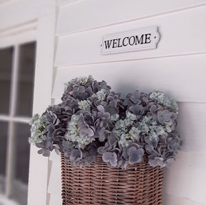 Give your guests a warm welcome with this Vintage Style Welcome Sign. Inspired by vintage enamel signs, this sturdy cast iron sign is white with raised black lettering and trim. (hardware not included.) 8.65”L x 2.15”H