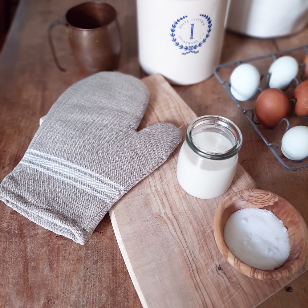 Our White Stripe Grain Sack Kitchen Oven Mitt offers farmhouse style with a French country twist. The relaxed elegance of this grain sack is perfect for a more old-world look. Perfect for everyday farmhouse cooking, the oven hand mitt features a rustic linen with a burlap color and classic white ticking stripe and a hoop for hanging. 100% Linen
