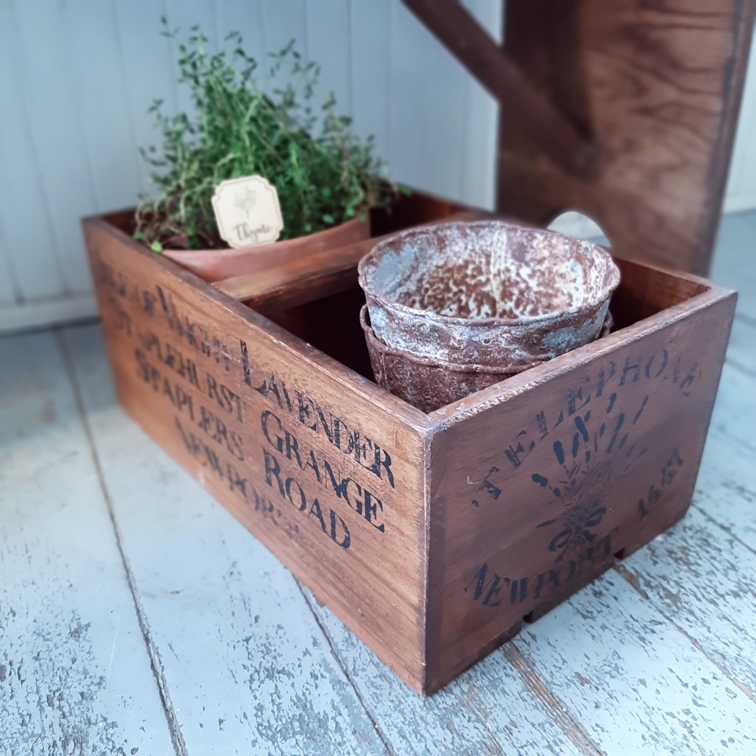 There are so many uses for this Vintage Style Wood Lavender Crate. Keep a mudroom organized or stash away root veggies in an old fashioned kitchen larder. Create an indoor herb garden by adding potted herbs to create a vintage style to your potting shed. Our Vintage Style Wood Lavender Crate includes the wooden crate with screen printed lavender logo and and a center piece to use as a handle, turning it into a garden tote.