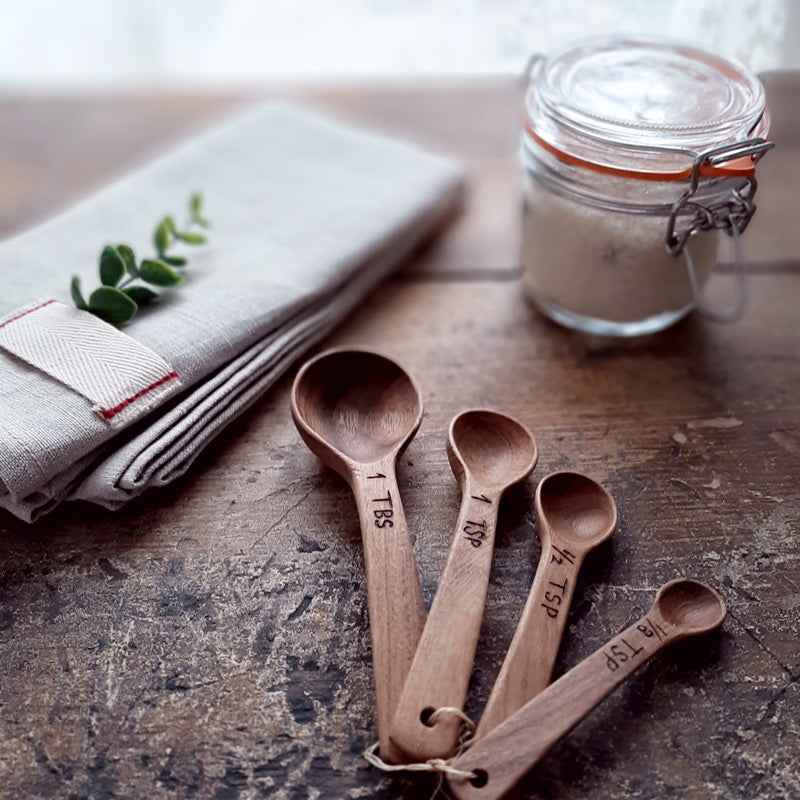 Bring rustic farmhouse style to your cooking with this Wood Measuring Spoon Set. These handmade wooden measuring spoons are so nice you won't want to use them and get them dirty! This set will complement any kitchen. Made of laurelwood, each is unique, no two are exactly alike! Handmade and fair trade. Includes: 1 tbs, 1 tsp, 1/2 tsp, 1/8 tsp. 